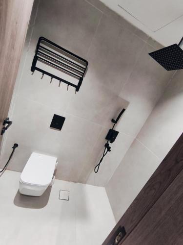 a bathroom with a toilet and a camera at شقق الإيجار - العروبه in Riyadh