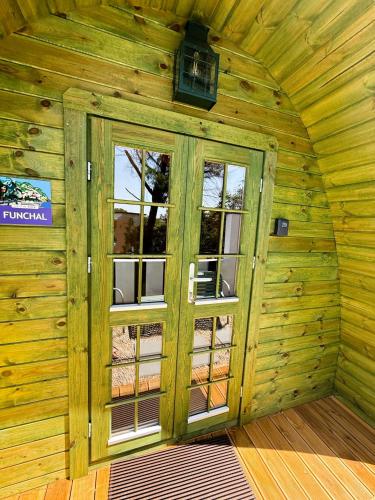 a room with a door in a wooden cabin at LEIRIA Side Bungalow in Leiria