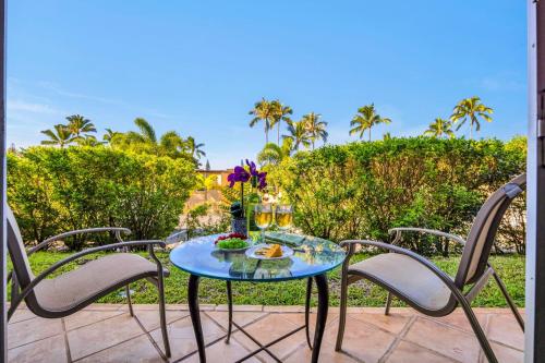 a table with a plate of food on a patio at Napili Ridge K6 in Napili-Honokowai