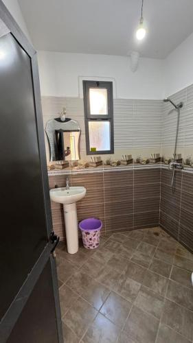 a bathroom with a sink and a toilet and a mirror at Sidi kaouki Private House in Sidi Kaouki