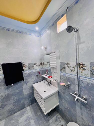 a bathroom with a sink and a shower at umer cottage in Murree