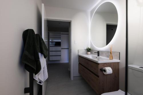 a bathroom with a sink and a mirror at Alpine Retreat in Methven
