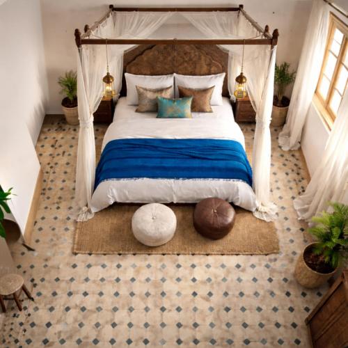 a bedroom with a large bed with a canopy at Villa El Houda in Souk el Had du Drâa