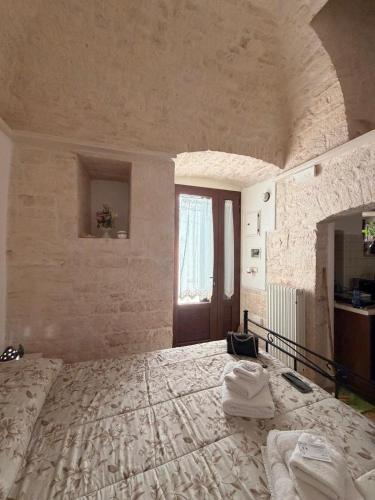 a bedroom with a large bed and a window at La casetta di zia Giuseppina in Alberobello