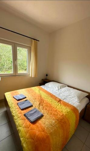a bedroom with a large bed with towels on it at Stunning Sea View in Central Postira in Postira