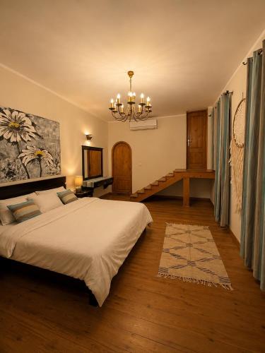 a bedroom with a large bed and a chandelier at Modern Villa in Dahab in Dahab