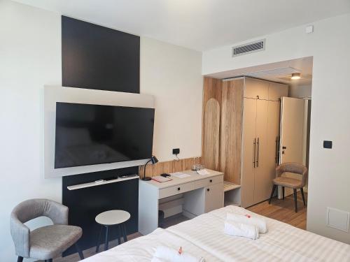 a bedroom with a bed with a large television on the wall at Zasavski Gurman in Dol pri Hrastniku