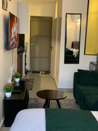 a living room with a green couch and a table at Tsavo Rising in Nairobi