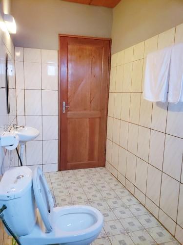 a bathroom with a toilet and a sink at M & S Multipurpose Center in Yaoundé