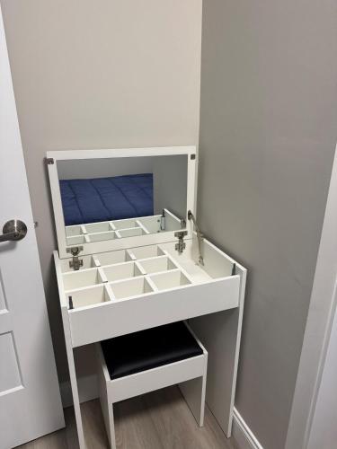 a white cabinet with a sink in a room at The Cozy Nook in Cochrane