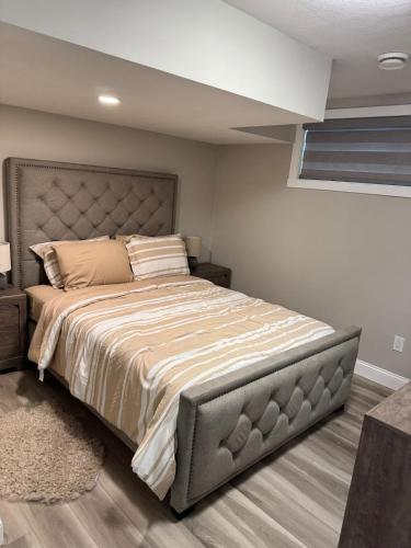a bedroom with a large bed in a room at The Cozy Nook in Cochrane