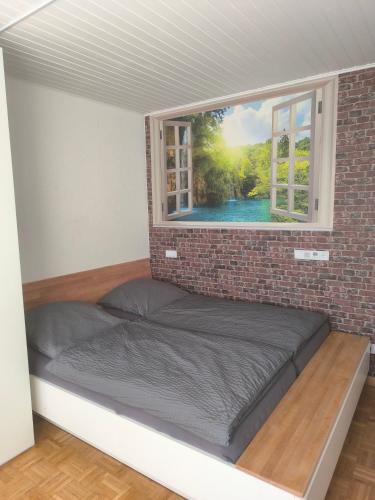 a bed in a room with a window at Willy und Gudrun in Rheda-Wiedenbrück