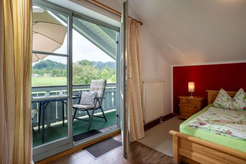 a bedroom with a bed and a balcony at Wellness Ferienwohnung mit Hallenbad und Sauna in Oberaudorf