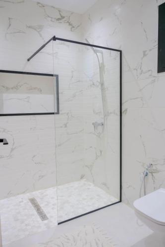 a shower with a glass door in a bathroom at Villa Ghizen in Fafou