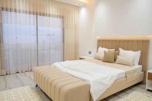 a bedroom with a large bed with a large window at Villa Ghizen in Fafou