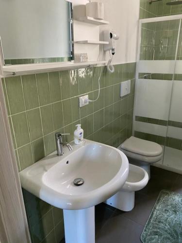 a bathroom with a sink and a toilet at La dimora del borgo antico in Pulsano