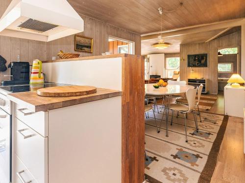 a kitchen and dining room with a table and chairs at 5 star holiday home in Væggerløse in Bøtø By