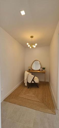 a room with a dressing table and a mirror at SeaFront Horizon in Sitio de Calahonda