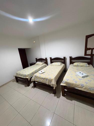 a room with two beds in a room at ConfortTrust Hotel in Ocaña