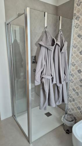 a bathroom with a shower with towels hanging from it at CasaLù in Lanciano