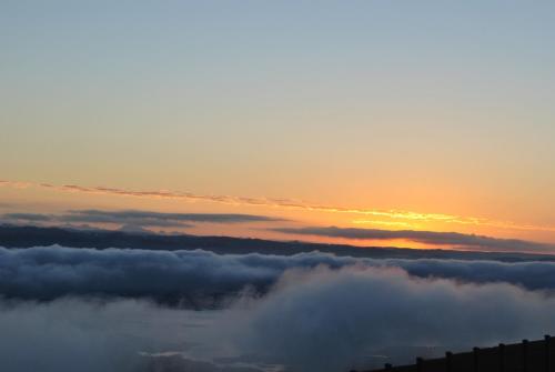 a view of the sunset from above the clouds at Villa Castollini in Brenton-on-Sea