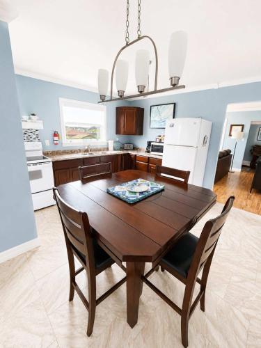 a kitchen with a wooden table and chairs in a room at Whistler's View in Twillingate