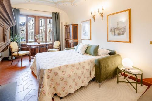 a bedroom with a bed and a dining room at Arezzo Centre, Prestigious Apartment with a View in Arezzo