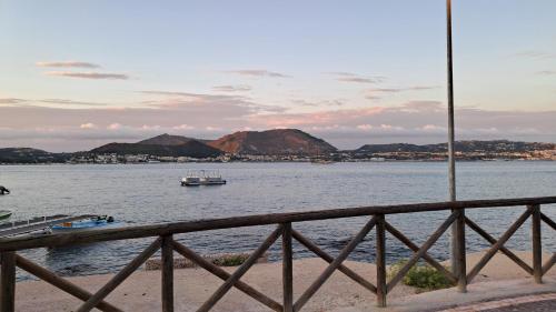a boat in a large body of water with mountains at Affitti Brevi da Rita in Monte di Procida