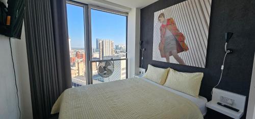 a bedroom with a bed and a large window at Shivay harmony in Birmingham
