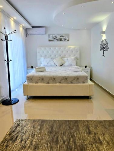 a bedroom with a large bed in a room at Villa Imperial in Dobra Voda