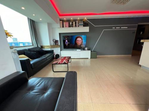 a living room with a couch and a flat screen tv at PENTHOUSE GROUP 4 Apartments in Bucharest