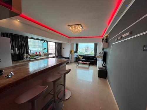a bar in a room with red lighting at PENTHOUSE GROUP 4 Apartments in Bucharest