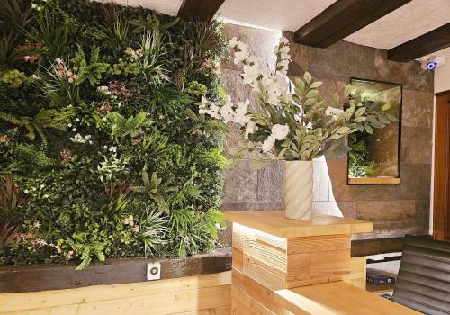 a room with a bunch of plants on the wall at L'Ecrin Vert & Spa in Kaysersberg