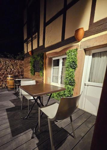a table and chairs sitting on a patio at L'Ecrin Vert & Spa in Kaysersberg