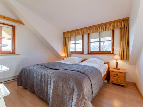 a bedroom with a bed and two windows at Fanningberg in Mariapfarr