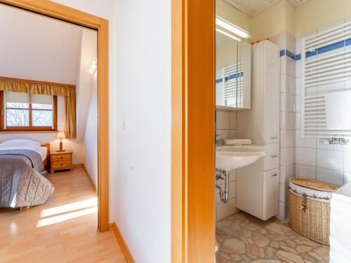 a bathroom with a bed and a sink in a room at Fanningberg in Mariapfarr