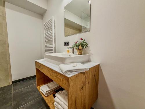 a bathroom with a white sink and a mirror at Bockblick Top 6 in Weisspriach