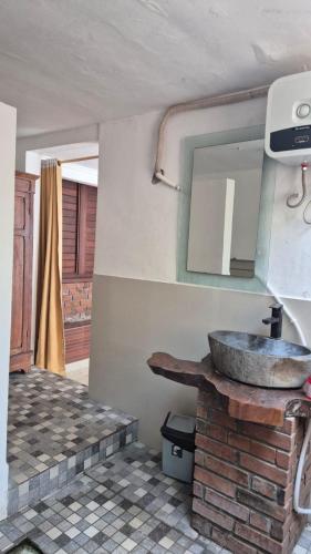 a bathroom with a sink and a mirror at Villa Intan 2 in Amed