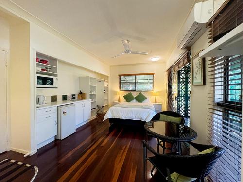a bedroom with a bed and a table and chairs at True North B&B in Horseshoe Bay