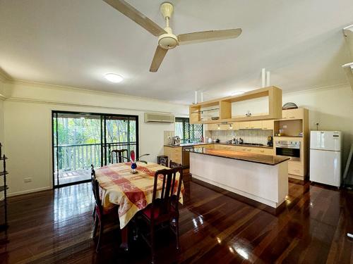 a large kitchen with a table and a ceiling fan at True North B&B in Horseshoe Bay
