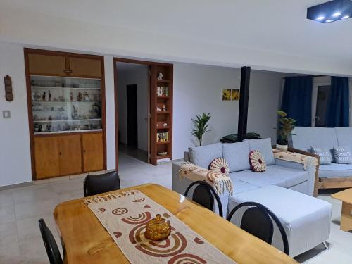 a living room with a table and a couch at Casa XENA in Río Cuarto