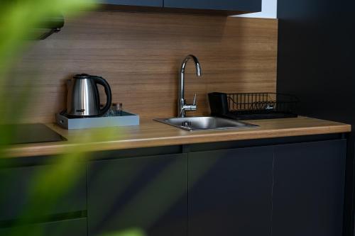 a kitchen with a sink and a kettle on a counter at Hana boutique apartments in Ulcinj