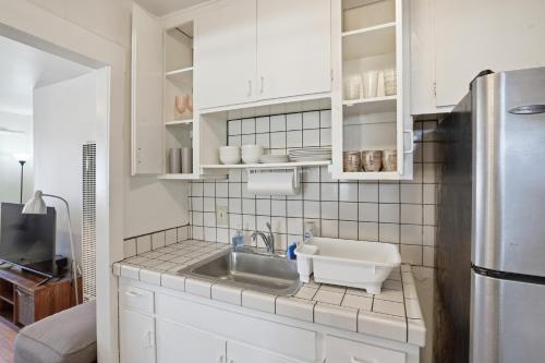 a kitchen with a sink and a refrigerator at Golden Hill 1 bedrooms in San Diego