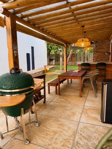 an outdoor patio with a table and a grill at Casa Naru in Atins