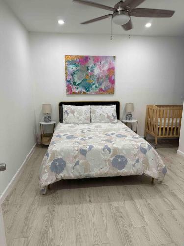 a bedroom with a bed and a painting on the wall at Cozy Apartment in Brownsville