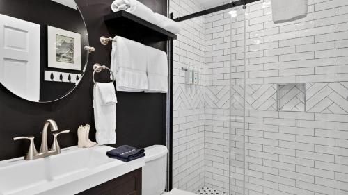 a bathroom with a shower and a sink and a mirror at Serenity by the Slopes in Vail