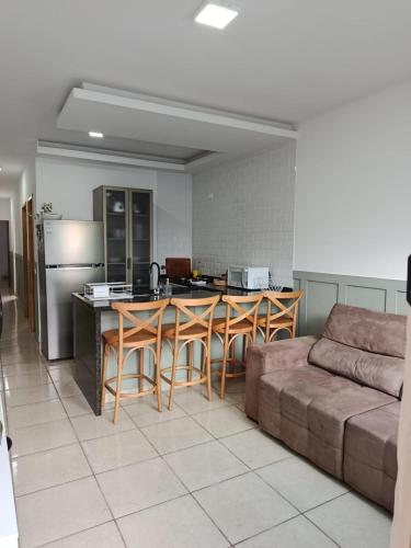a kitchen with a couch and a kitchen with a table at Casa em Sorocaba para até 4 pessoas in Sorocaba