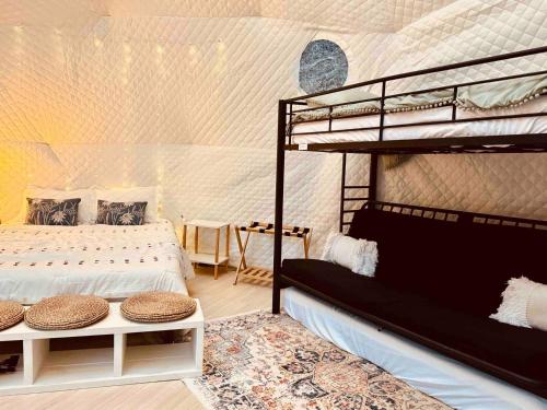 a bedroom with two bunk beds in a room at The Perch Glamping by Rafting in Cosby