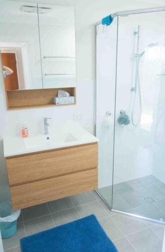 a bathroom with a sink and a shower at Glistening Waters in Tathra