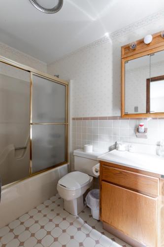 a bathroom with a toilet and a sink and a shower at Rustic Mountain view Cabin 5 mins to Ski Area! in Windham